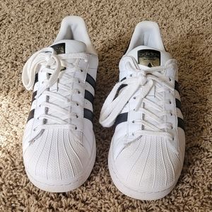 Selling a used pair of Adidas Superstars black on white. Male 9 female 10